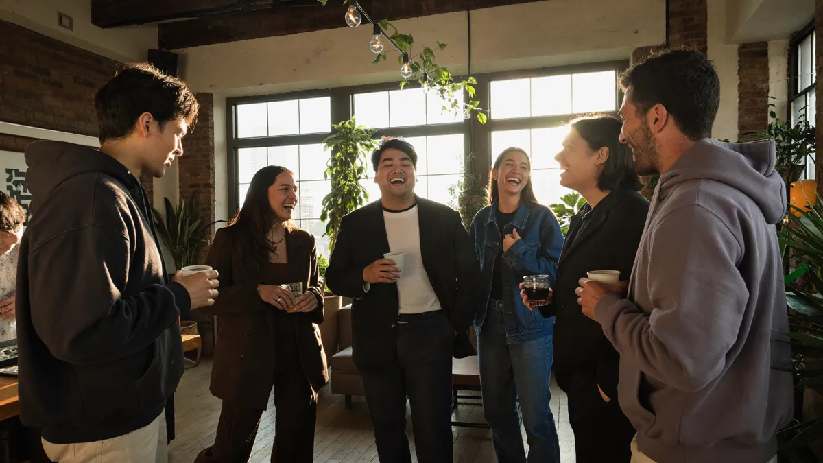 An evening networking event of founders and high performers in a warm loft