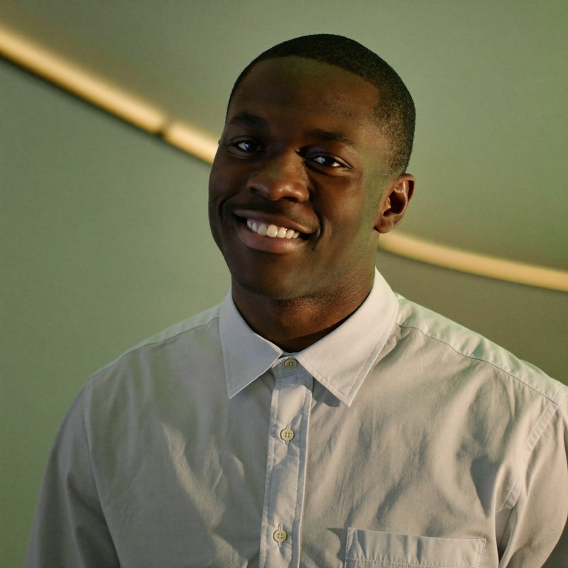 Black man in a casual button-up, recently laid off